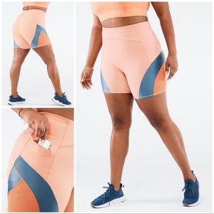 Fabletics Motion 365 neon orange biker shorts